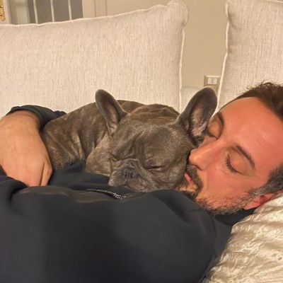 Marco Belinelli and his dog taking a nap together.
